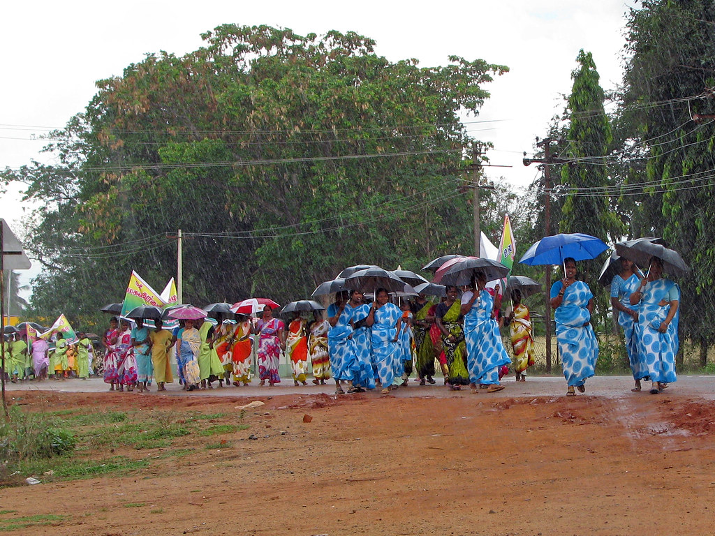 Indian volunteers planting saplings on a village outreach day